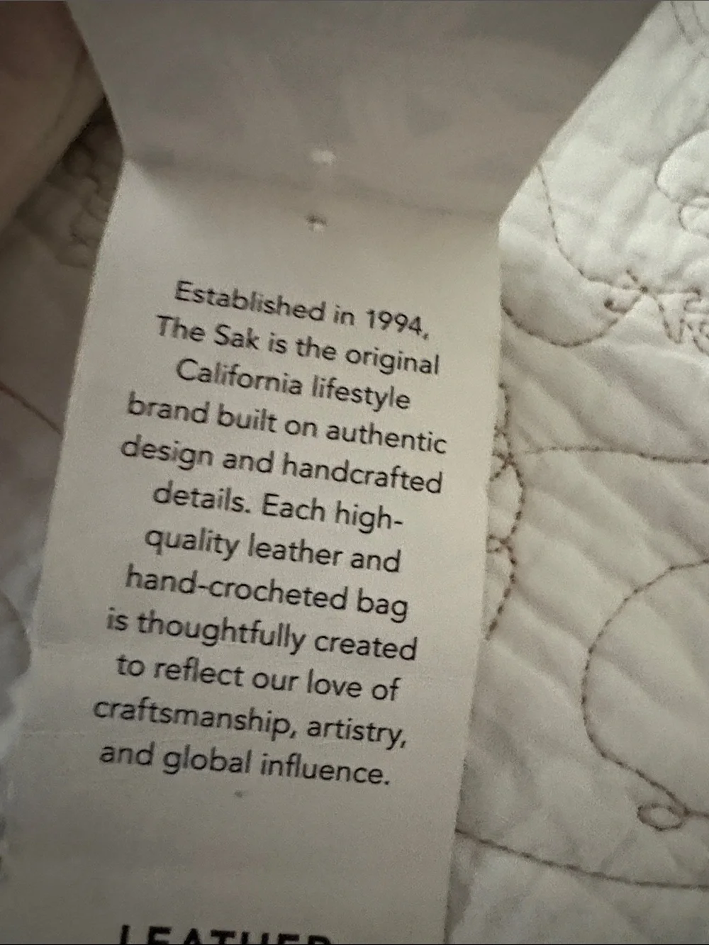 The Sak Leather Messenger Bag in Black and Cream Woven Front